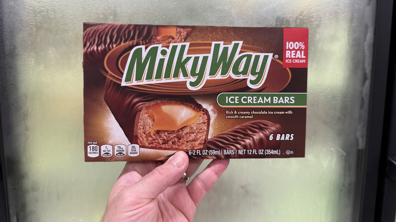 Hand holding a box of Milky Way Ice Cream Bars