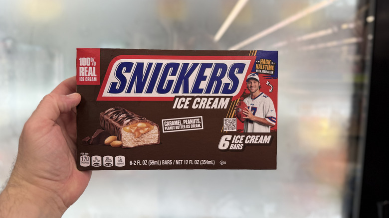 Hand holding a box of Snickers Ice Cream Bars