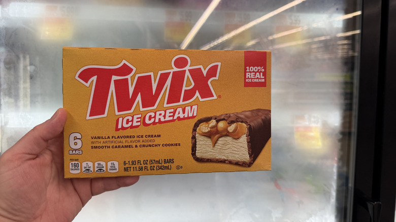 Hand holding a box of Twix Ice Cream Bars