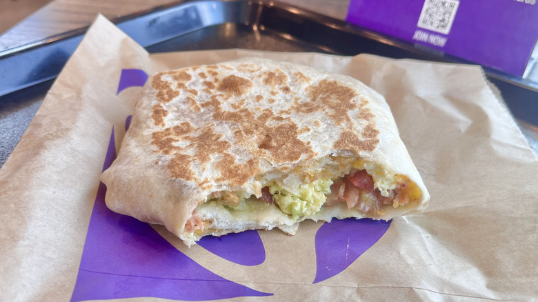 Breakfast California Crunchwrap with pieces bitten off