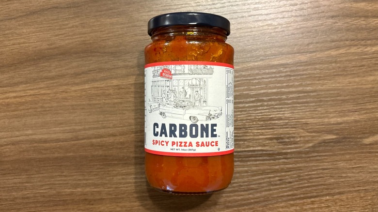 Carbone Spicy Pizza Sauce jar on wooden table