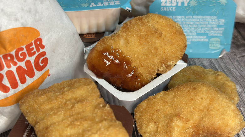 Burger King Chicken Nuggets and dipping sauce. One nugget in BBQ sauce