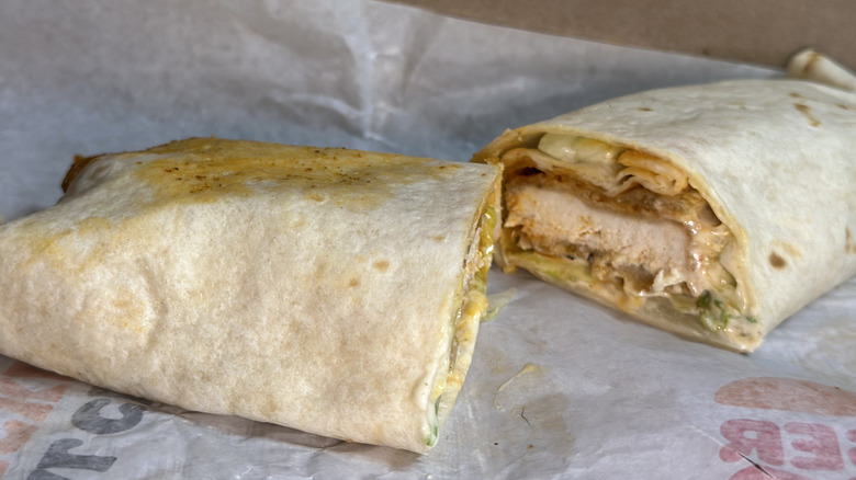 Burger King Spicy Flame-Grilled Chicken Wrap cut in half on wax wrapper