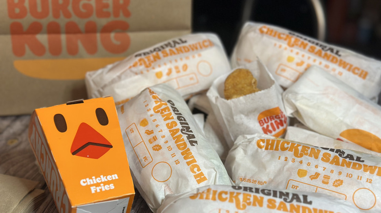 Piles of Burger King's chicken products in front of burger king logo