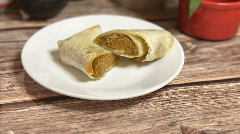 Tina's Red Hot Beef Burrito on wooden platform with red ramekin