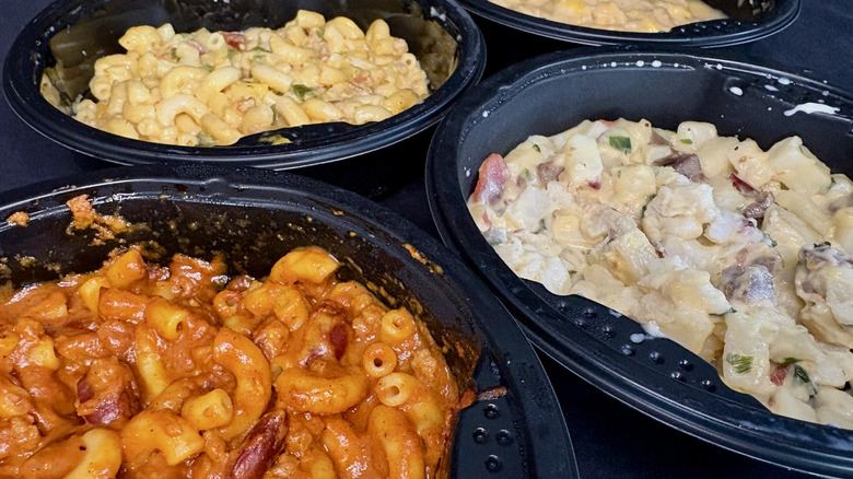 Several bowls of microwaved Chunky frozen meals on a black background