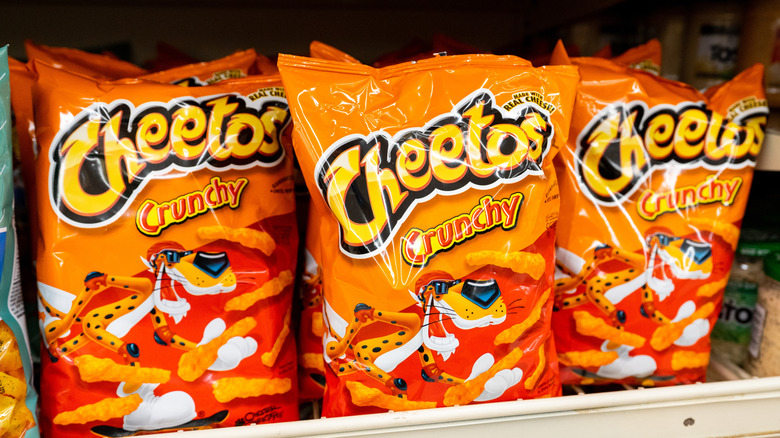 Cheetos Crunchy cheese-flavored snack bags displayed on a grocery store retail shelf.