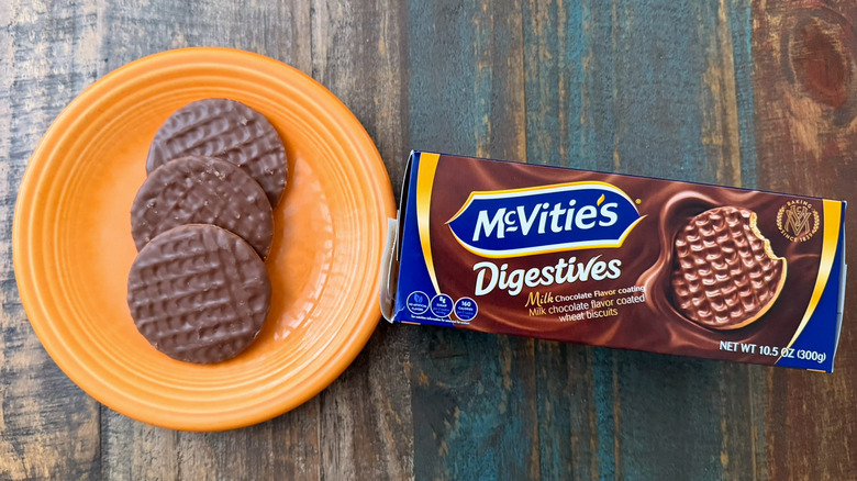 A plate of McVitie's milk chocolate digestive biscuits next to the package