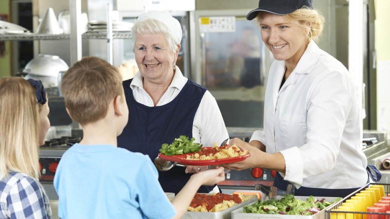 Kids being served lunch in school cafeteria