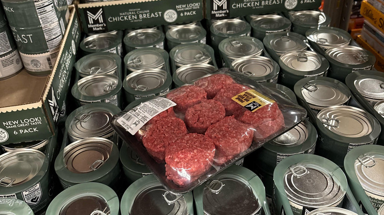 A package of Kirkland beef patties left on a case of canned chicken breast