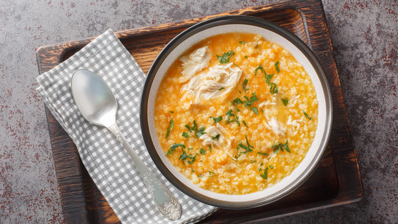 Top view of a bowl of pastina soup with chicken