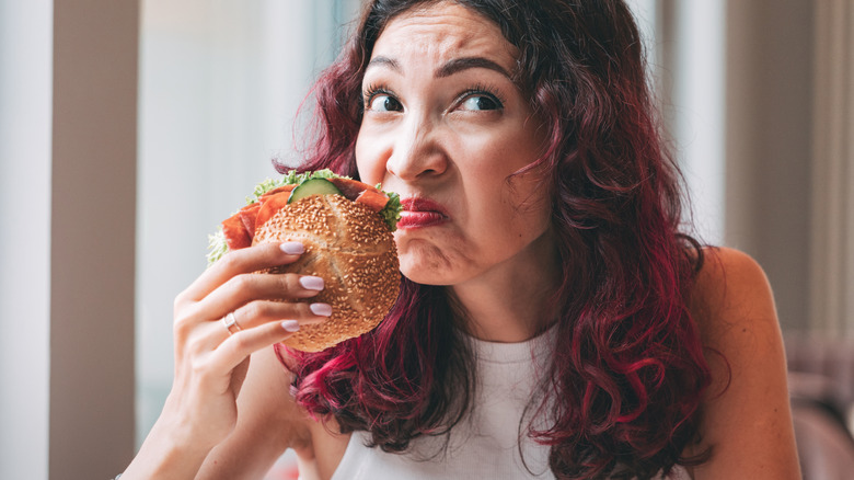 A customer sniffing a burger.