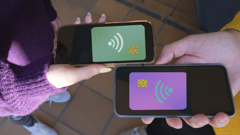 Two people make a money transaction using their phones