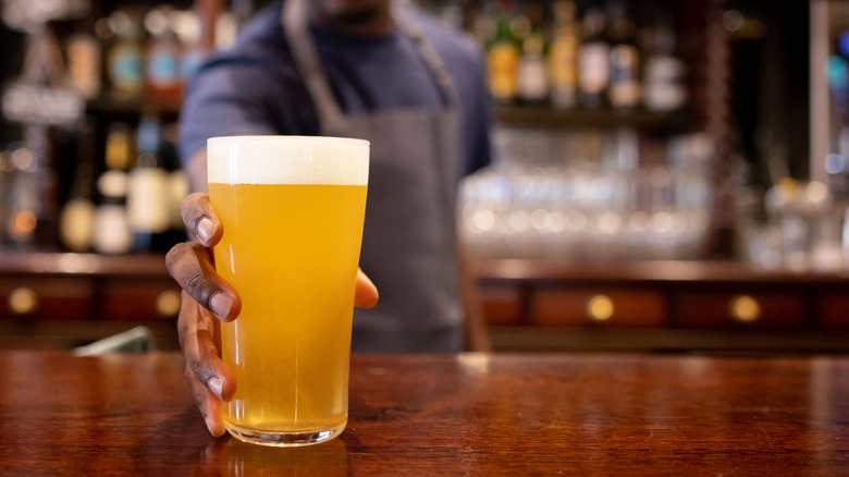 Bartender serving a beer at the bar