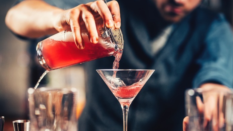 Close-up of a bartender pouring a drink.
