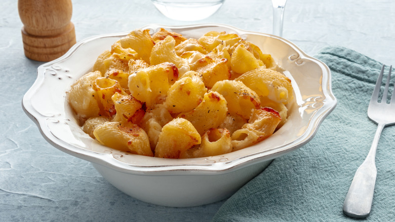 A bowl of baked mac and cheese with a fork