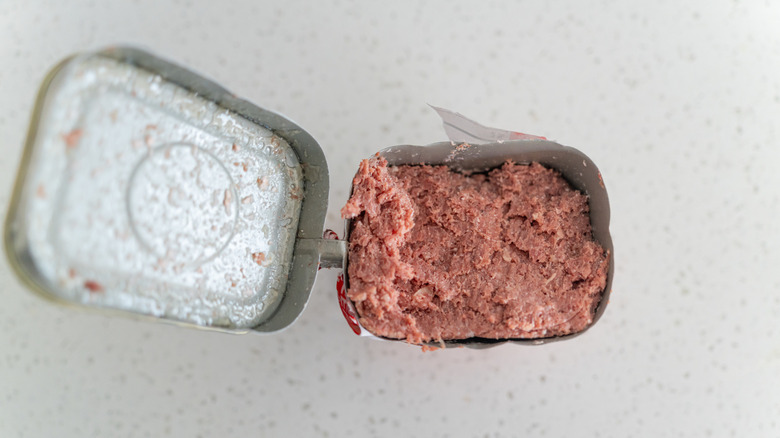 aerial view of opened can of corned beef on speckled surface