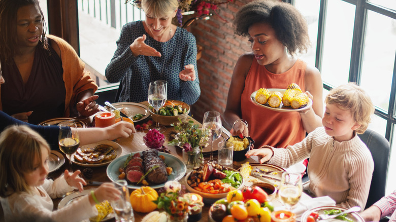 Diverse group of friends dining at a table.