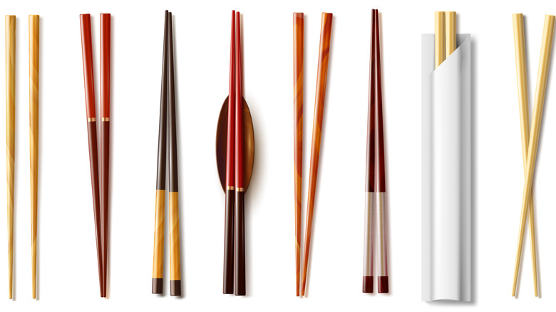 An array of chopsticks against a white background