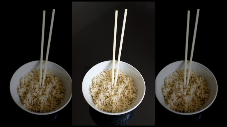 Chopsticks sticking out of a bowl of rice, mirrored