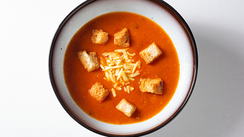 bowl of tomato soup with croutons and cheese