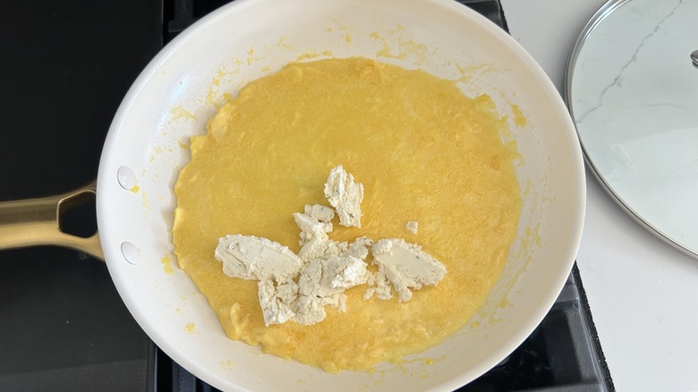 Partially cooked omelet with cheese