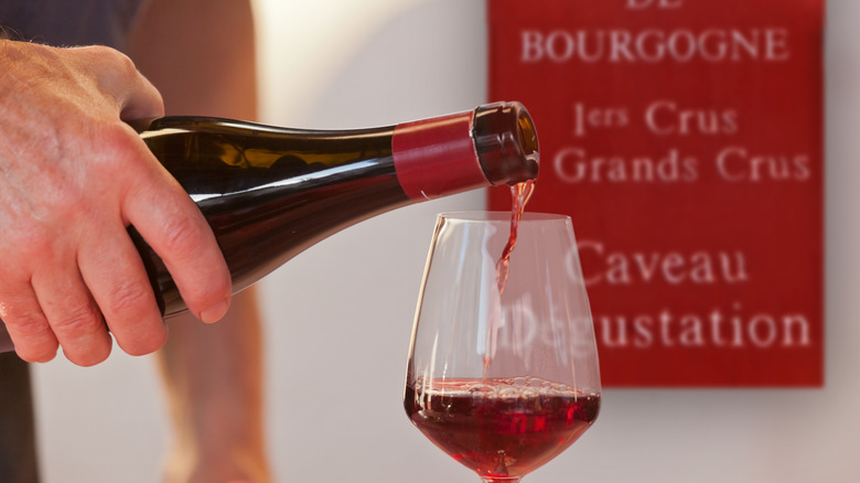 Pouring a glass of red burgundy wine