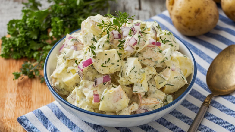 Creamy salad of tender potatoes tossed in mayonnaise or vinaigrette, enhanced with herbs, onions, and sometimes eggs or bacon.