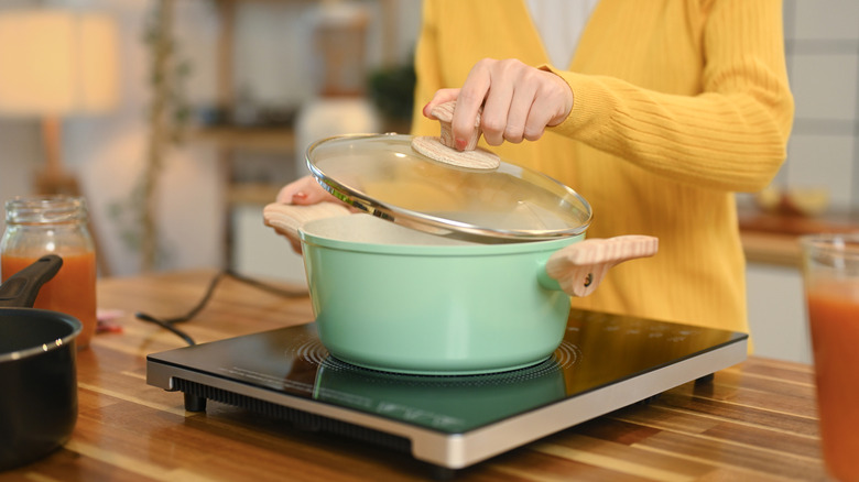Woman cooking on cook plate