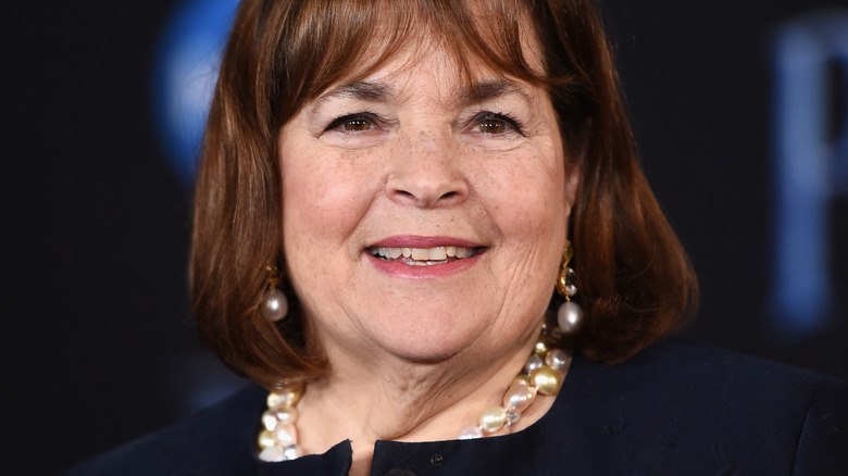 Ina Garten smiles in pearl jewelry at an event
