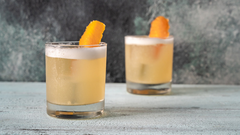 Two whiskey sours with egg added, making them Boston Sours