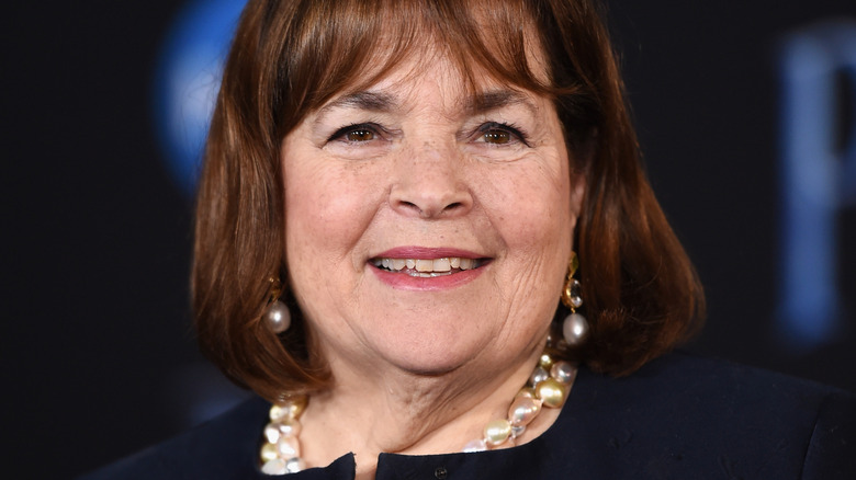 Ina Garten smiles in pearl jewelry at an event