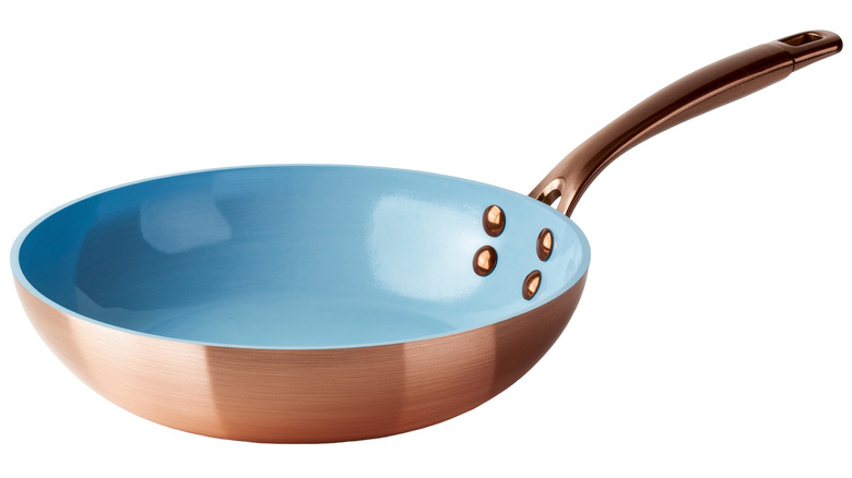 non-induction-friendly copper frying pan with a blue ceramic lining