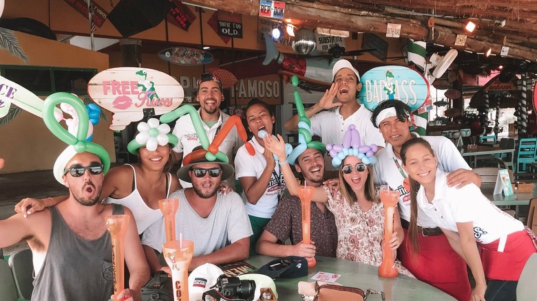 Group of patrons at Señor Frog's posing with staff