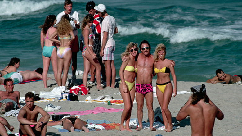 Spring breakers getting their photo taken at the beach