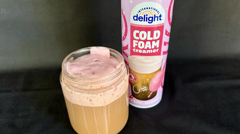 cold foam creamer next to coffee with pink foam on it