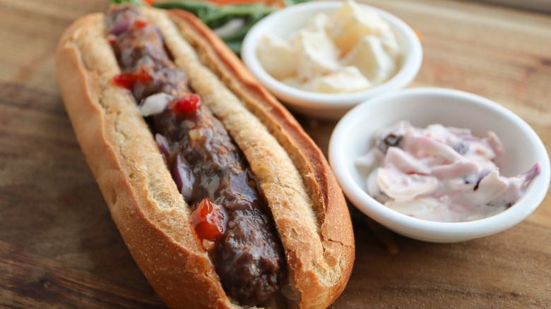 Boerewors sausage in bun with side dishes