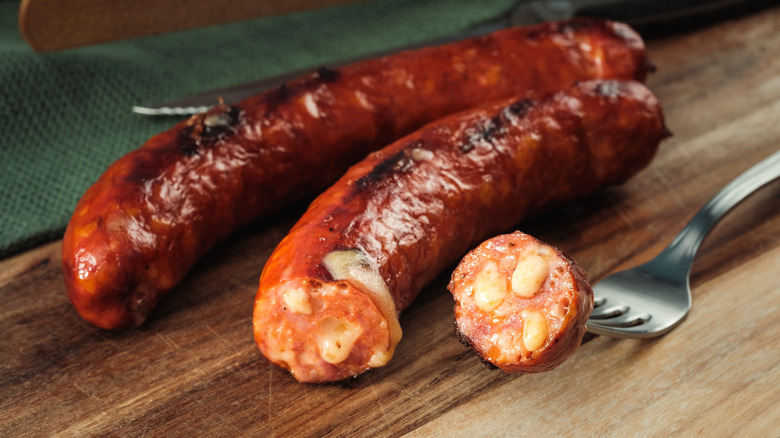 Käsekrainer cheese sausages on cutting board