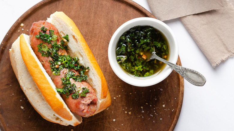 Salchicha parrillera in a bun with chimichurri