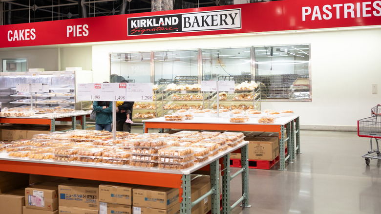 The inside of a Costco bakery is shown with pastries and cakes