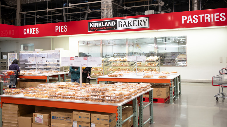 The inside of a Costco bakery is shown with pastries and cakes