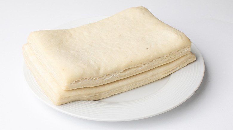 Unleavened dough is stacked on a white plate