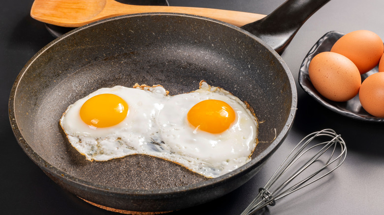 fried eggs in a black pan