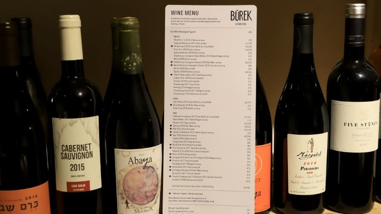 Bottles of wine standing together with a wine list.