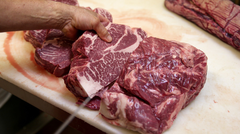 Cutting a big chunk of meat