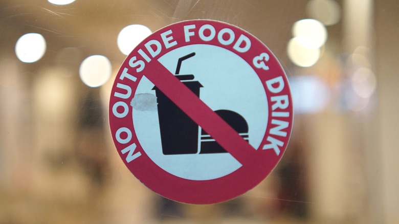 Sign on window reading "No outside food and drink"