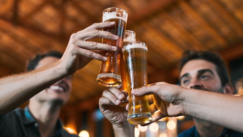 group of people toasting beer at a restaurant