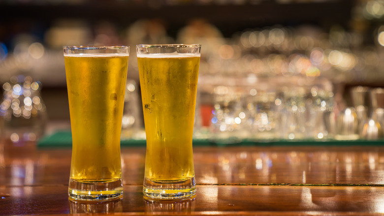 glasses of beer on a bar counter