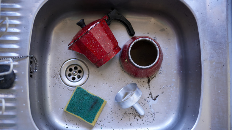An espresso percolator in a sink.
