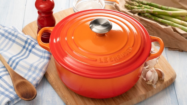 Le Creuset dutch oven on wood cutting board